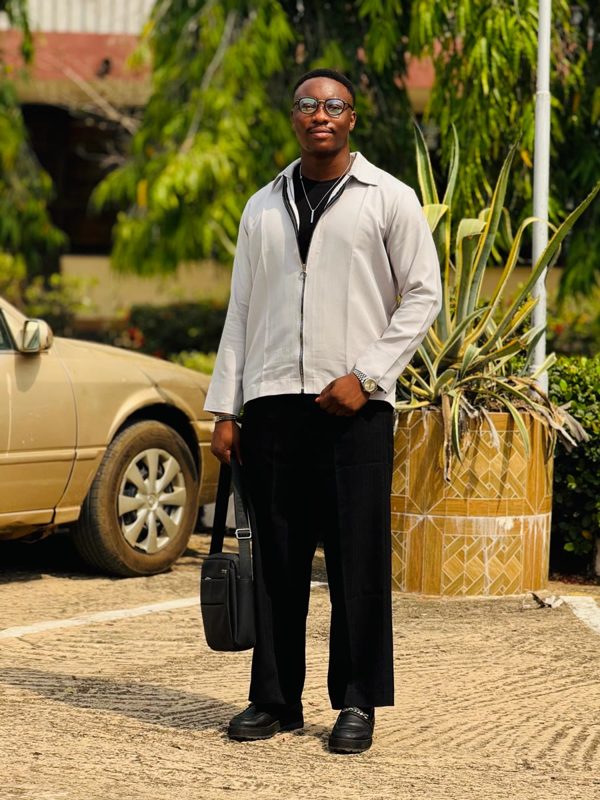Joel standing outdoors in a grey jacket